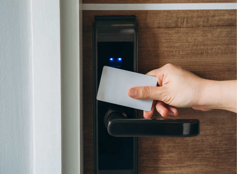 image of a person scanning their access card on door access control system