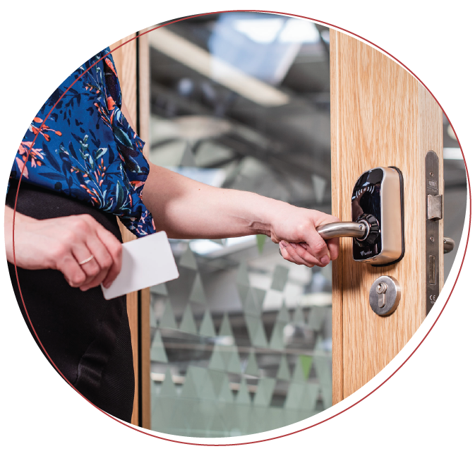 School teacher unlocking a paxton door handle for access control